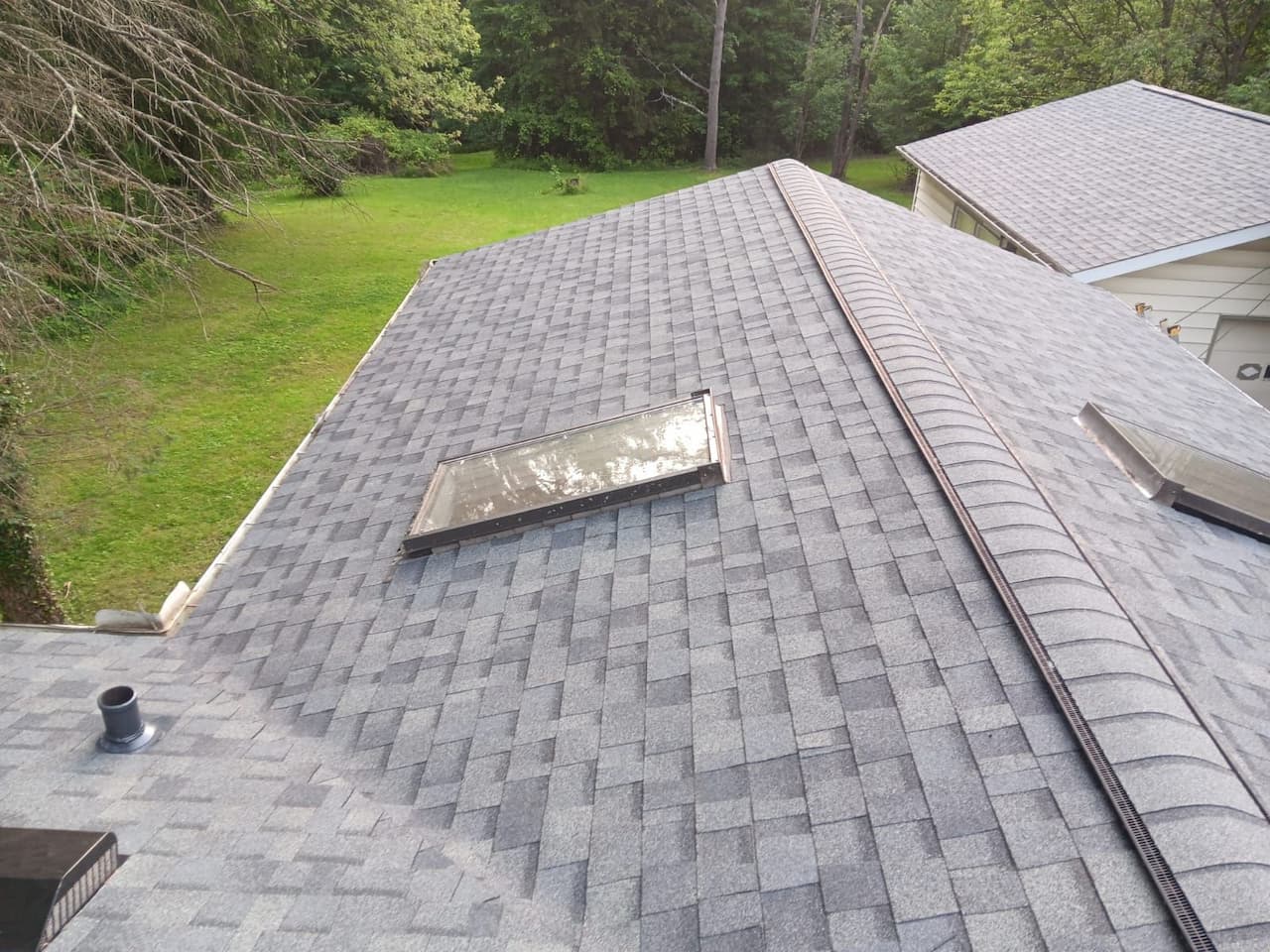 An aerial view of a gray shingled roof with keywords incorporated for SEO work.