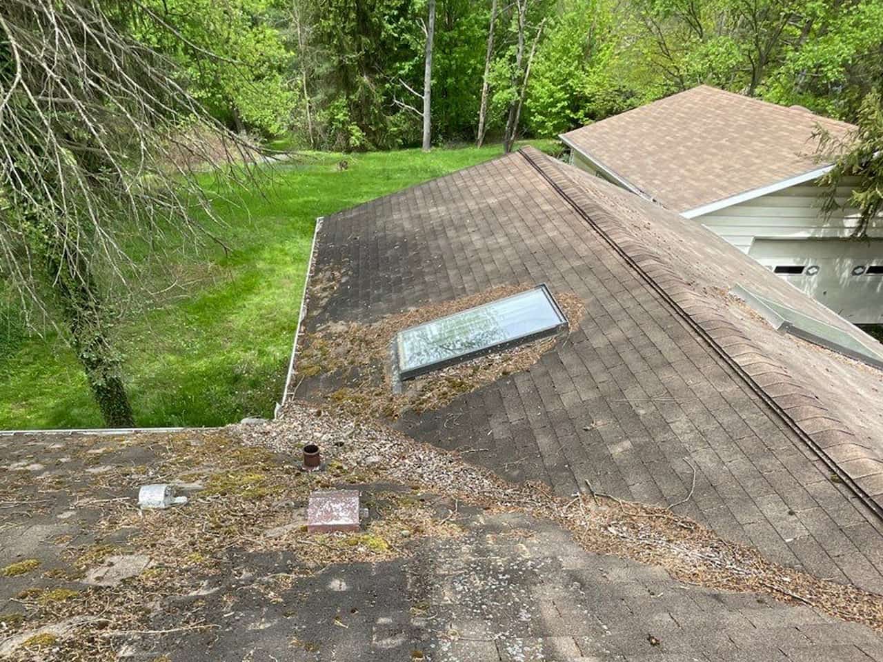 An aerial view of a roof with a skylight captured during work activities.