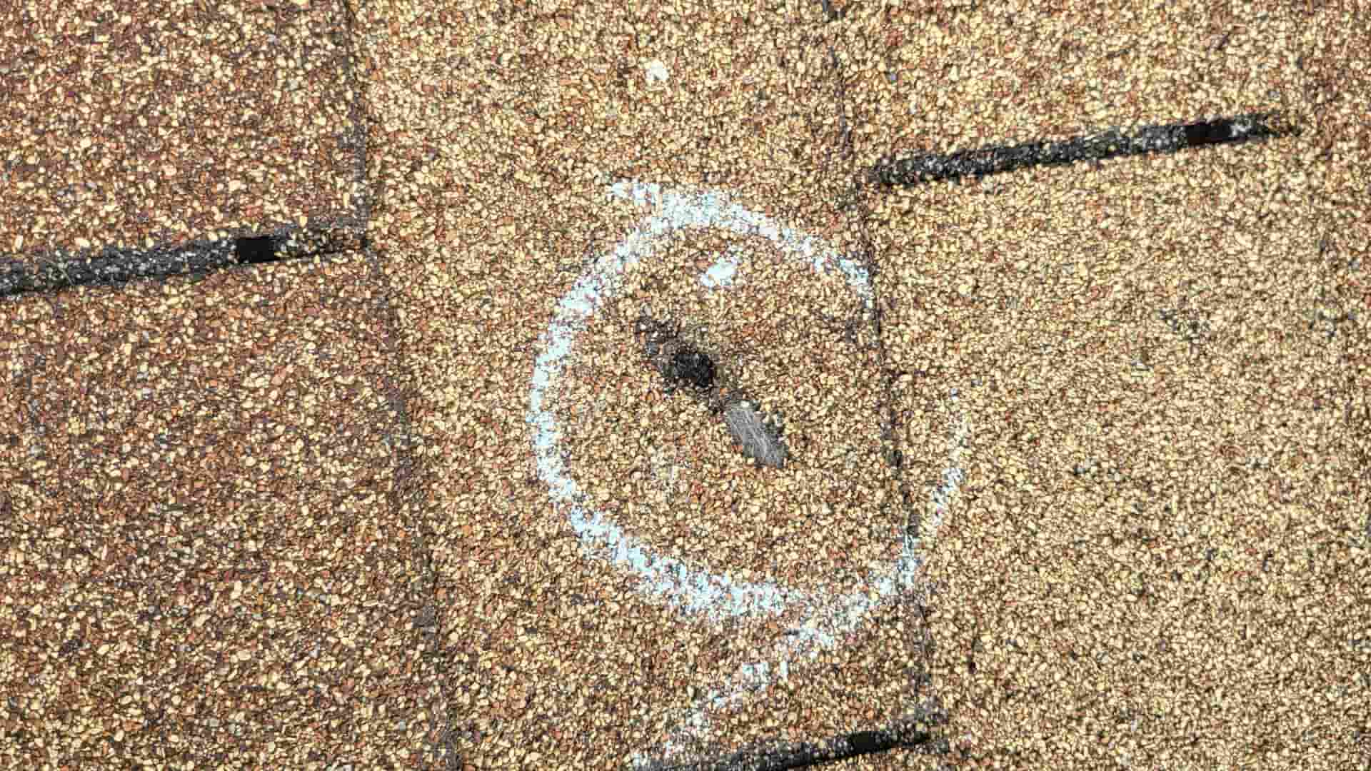 An image of a spot on a roof that may be damaged in a hail storm.