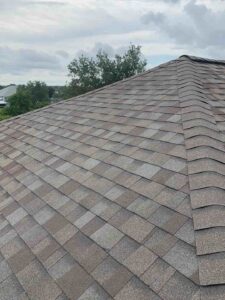 A roof with a brown shingled roof.