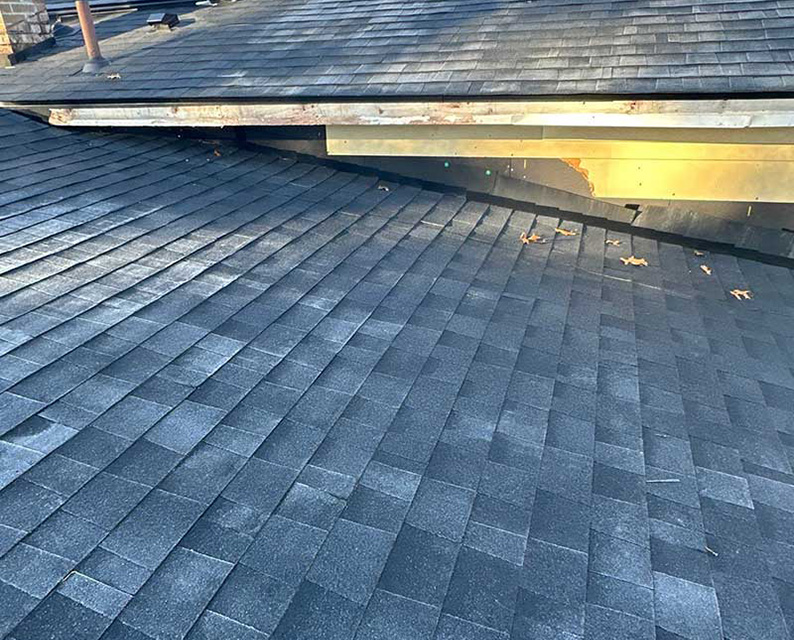 A roof with black shingles.