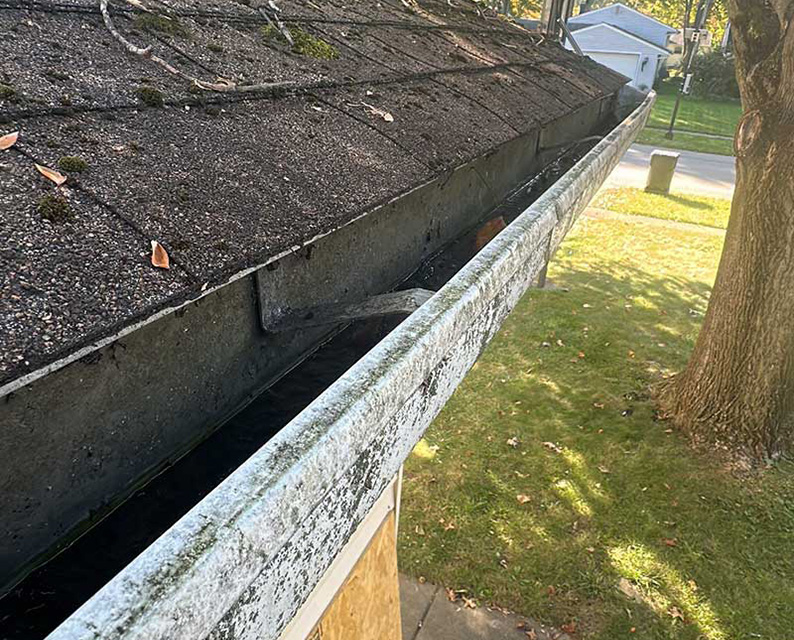 A new house with a leaking roof and gutters.